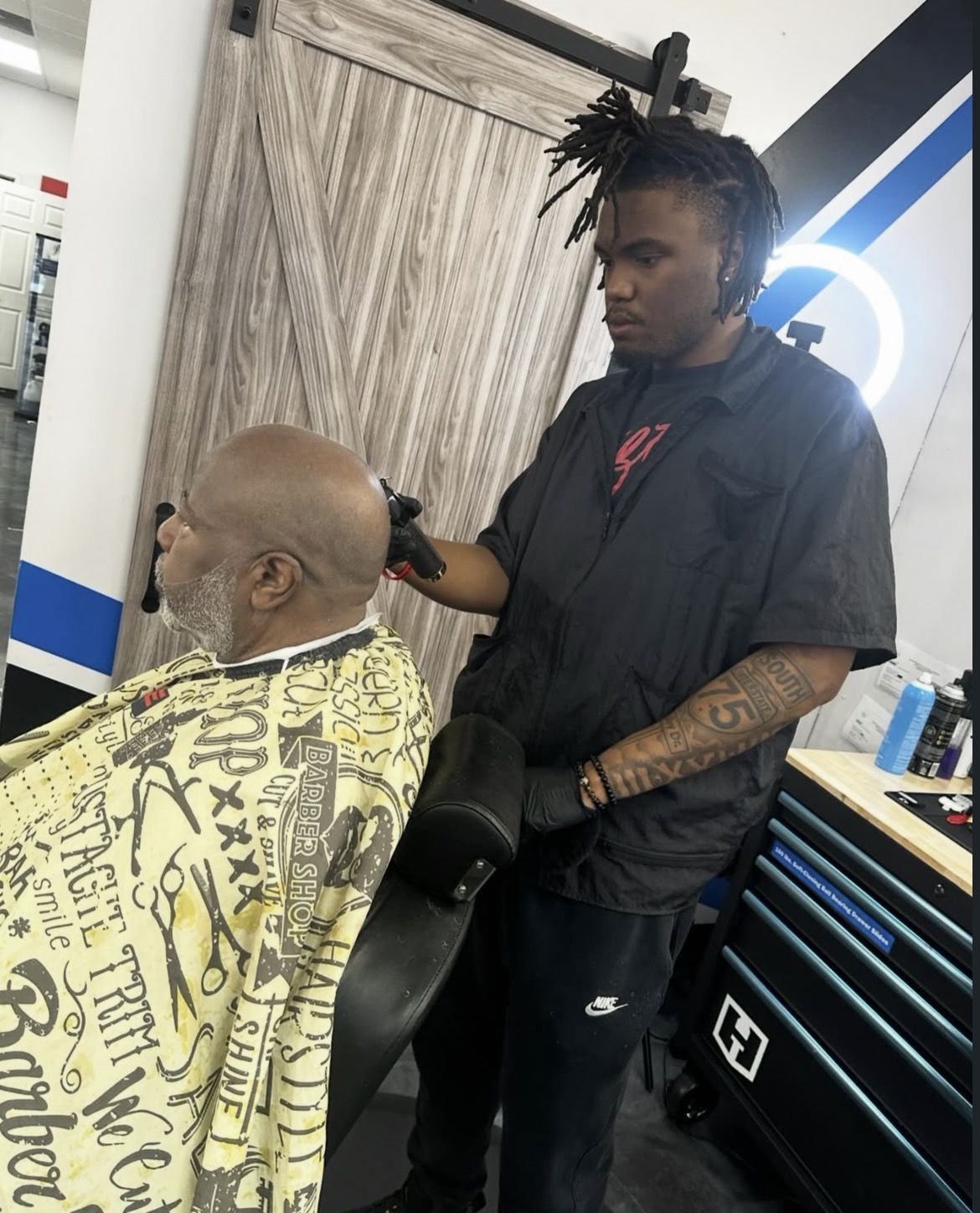Josh, barber and owner of Cuts By HBK Josh, at work in his Locust Grove barbershop